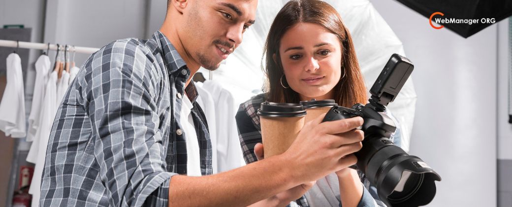 צילום למתחילים – הרגע שבו אתם מפסיקים לצלם ומתחילים לראות - ניתן לראות 2 צלמים גבר ואישה מחזיקים מצלמה ומסתכלים עךליה ובצד ימין למעלה לוגו אתר blog.webmanager